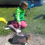 Cooking marshmallows on his own fire