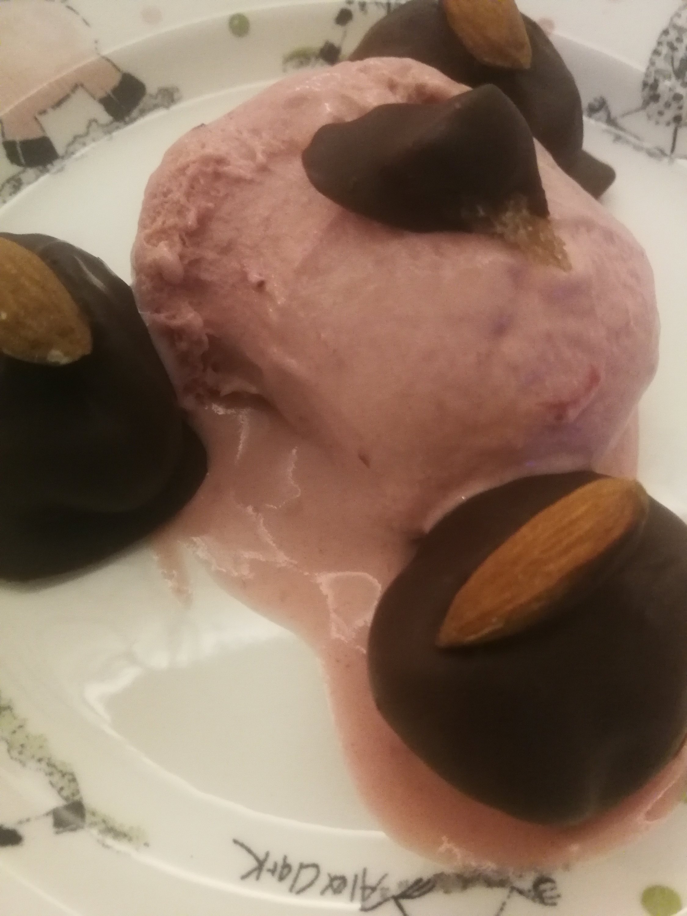 Baked figs stuffed with almond and crystallized ginger, dipped in chocolate with strawberry gelato