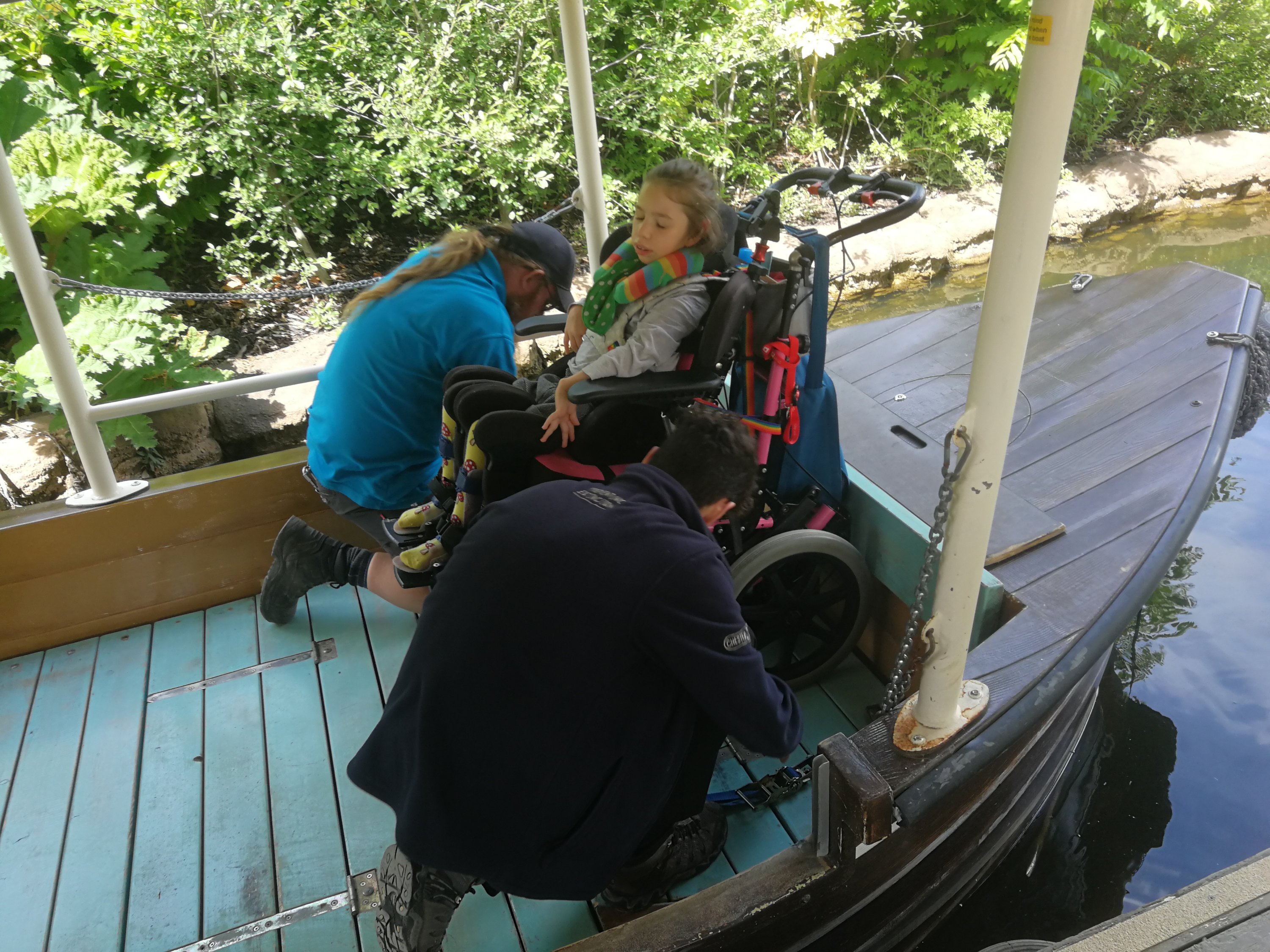 Wheelchair being secured into the boat by Chester Zoo staff