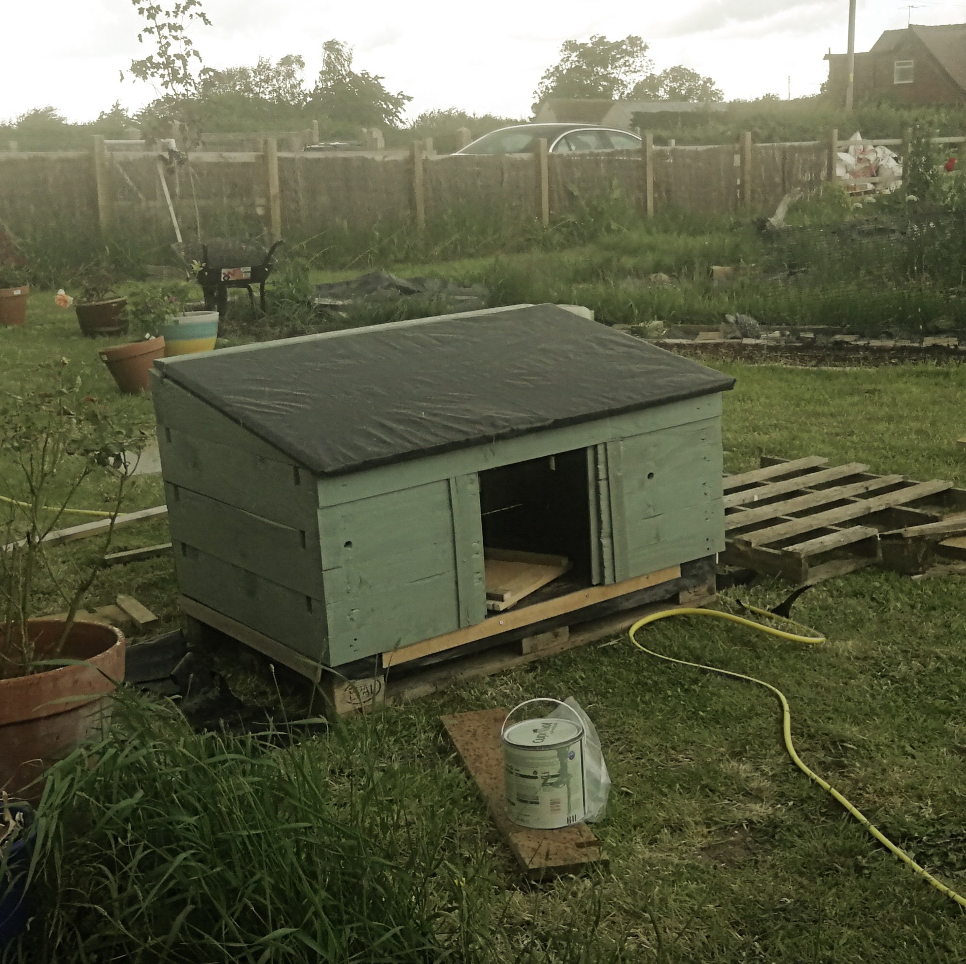 Duck house with the roof on but pouring down with rain